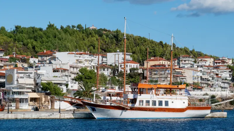 Two Moored Sailboats Near Pier Neos Marmaras Buildings Hill With Multiple Greenery Greece